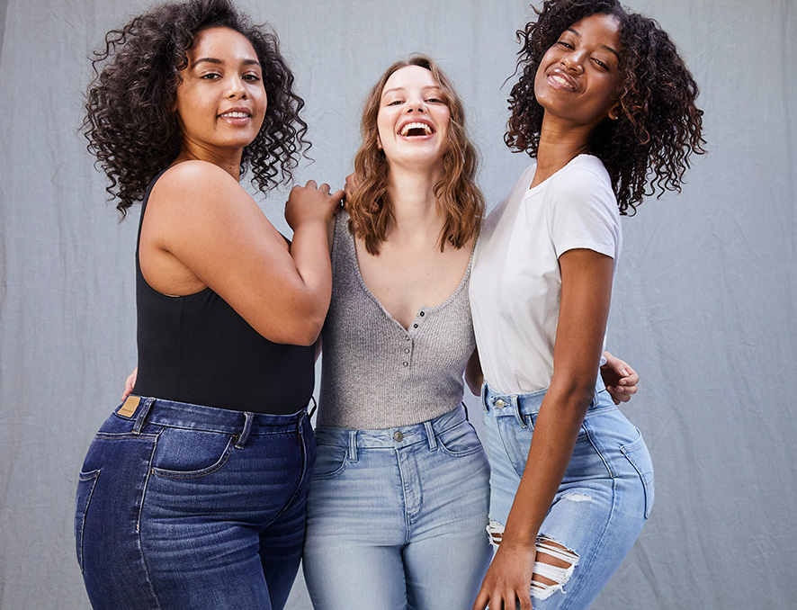 Three women wearing American Eagle Curvy Jeans