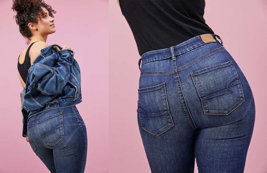 Woman wearing dark wash AE Curvy Jeans with a black tank top and denim jacket