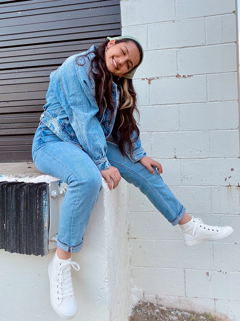 woman wearing a jean jacket and light wash jeans