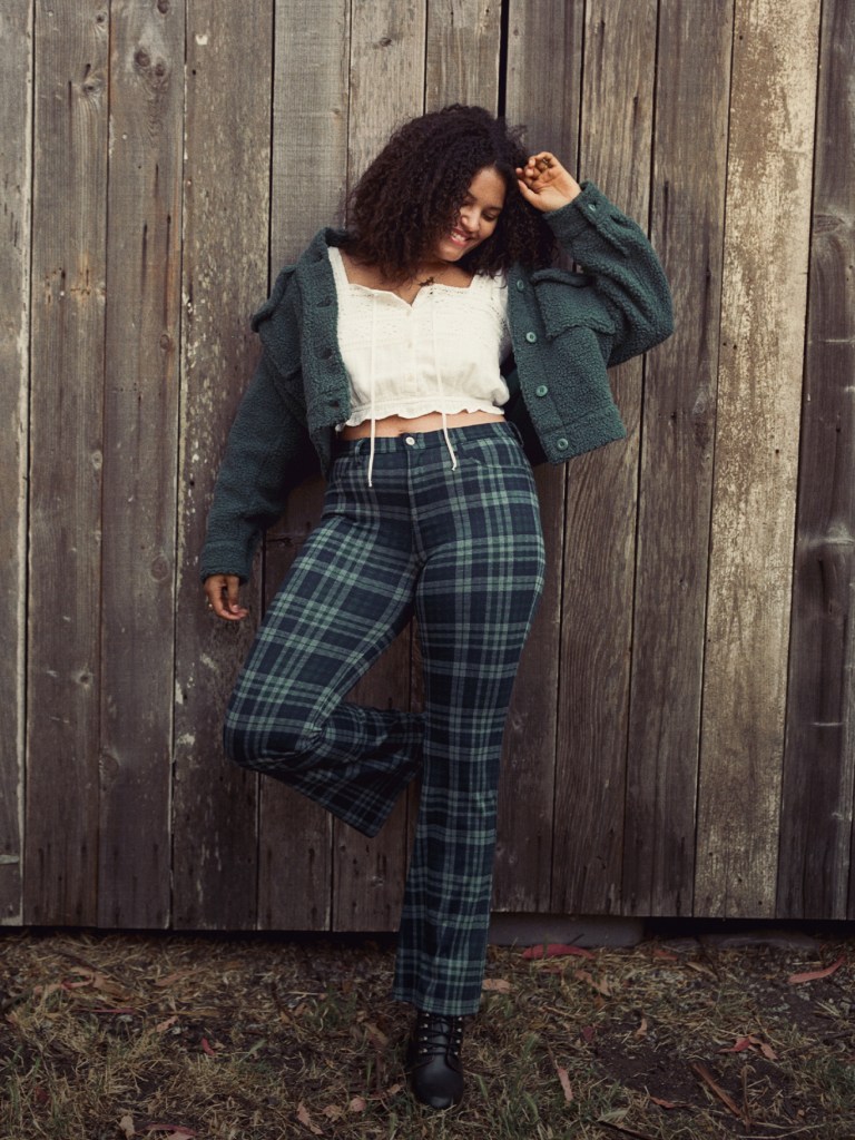 woman wearing plaid pants and a white shirt