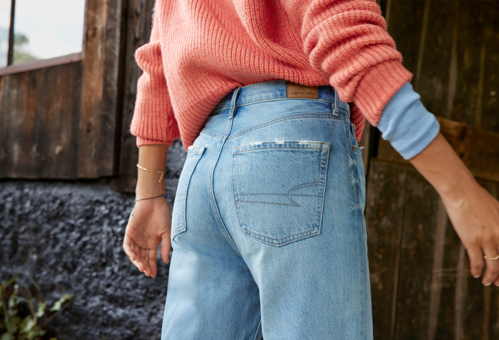 close up view of a woman wearing American Eagle jeans and a sweater