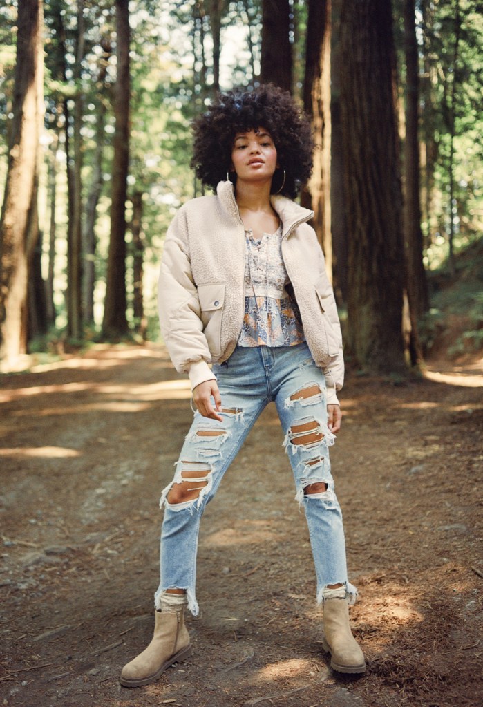 woman wearing American Eagle ripped jeans and a white jacket