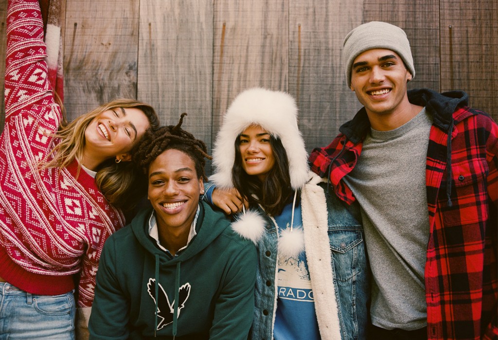 four people wearing American Eagle sweaters, hoodies, jackets, and flannel shirts