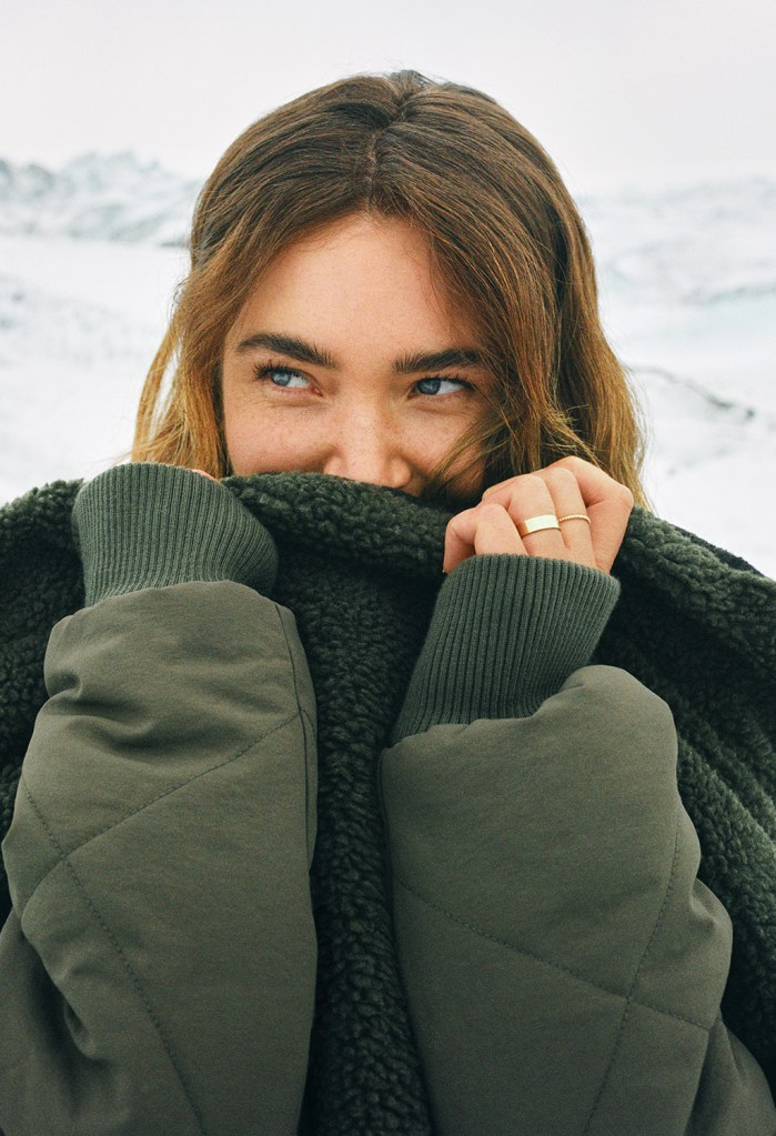 woman wearing a green puffer coat