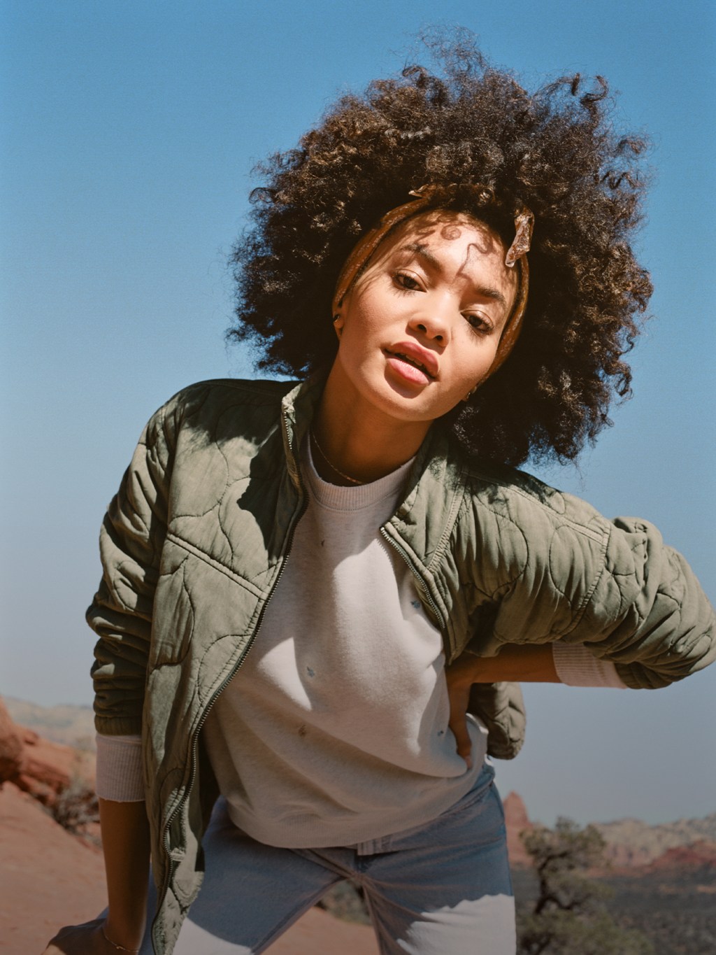 woman wearing a sweatshirt and green jacket