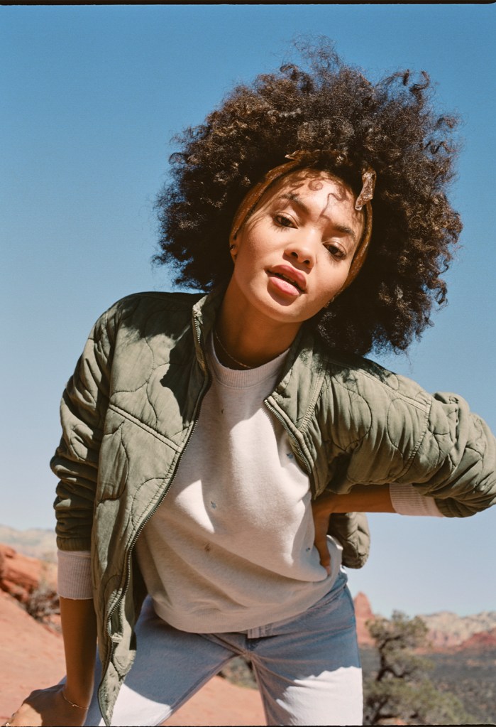 woman wearing a sweatshirt and green jacket