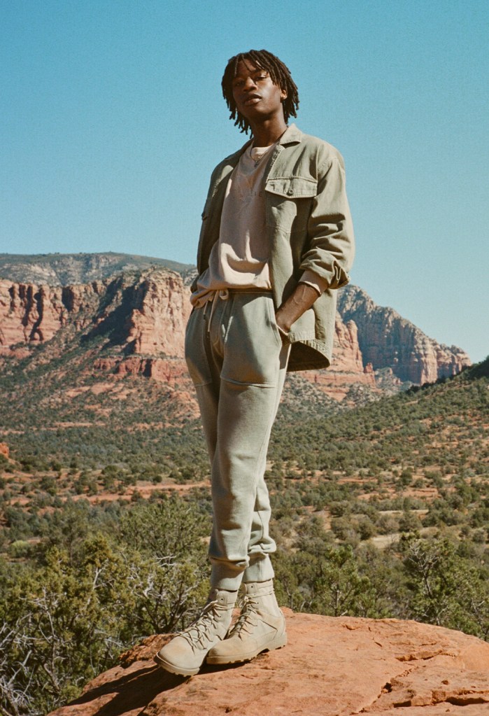 guy wearing green joggers, a t-shirt, and a green jacket