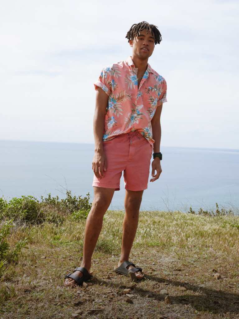 guy wearing pink Hawaiian camp collar shirt and pink shorts from American Eagle
