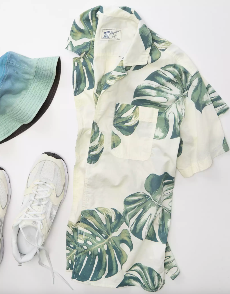 white and green tropical camp collar shirt, blue bucket hat, and white sneakers from American Eagle