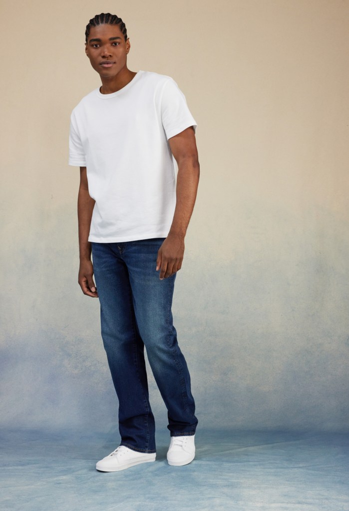 guy wearing a white tshirt and dark wash bootcut jeans from American Eagle