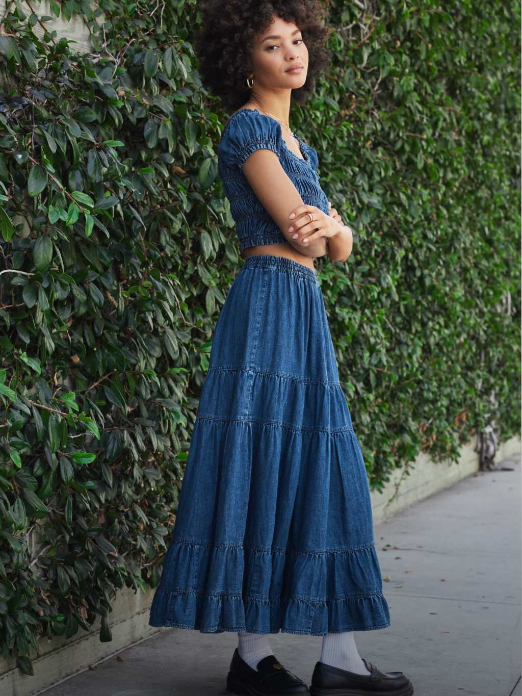 a girl wearing a blue denim crop top and long blue maxi skirt from american eagle