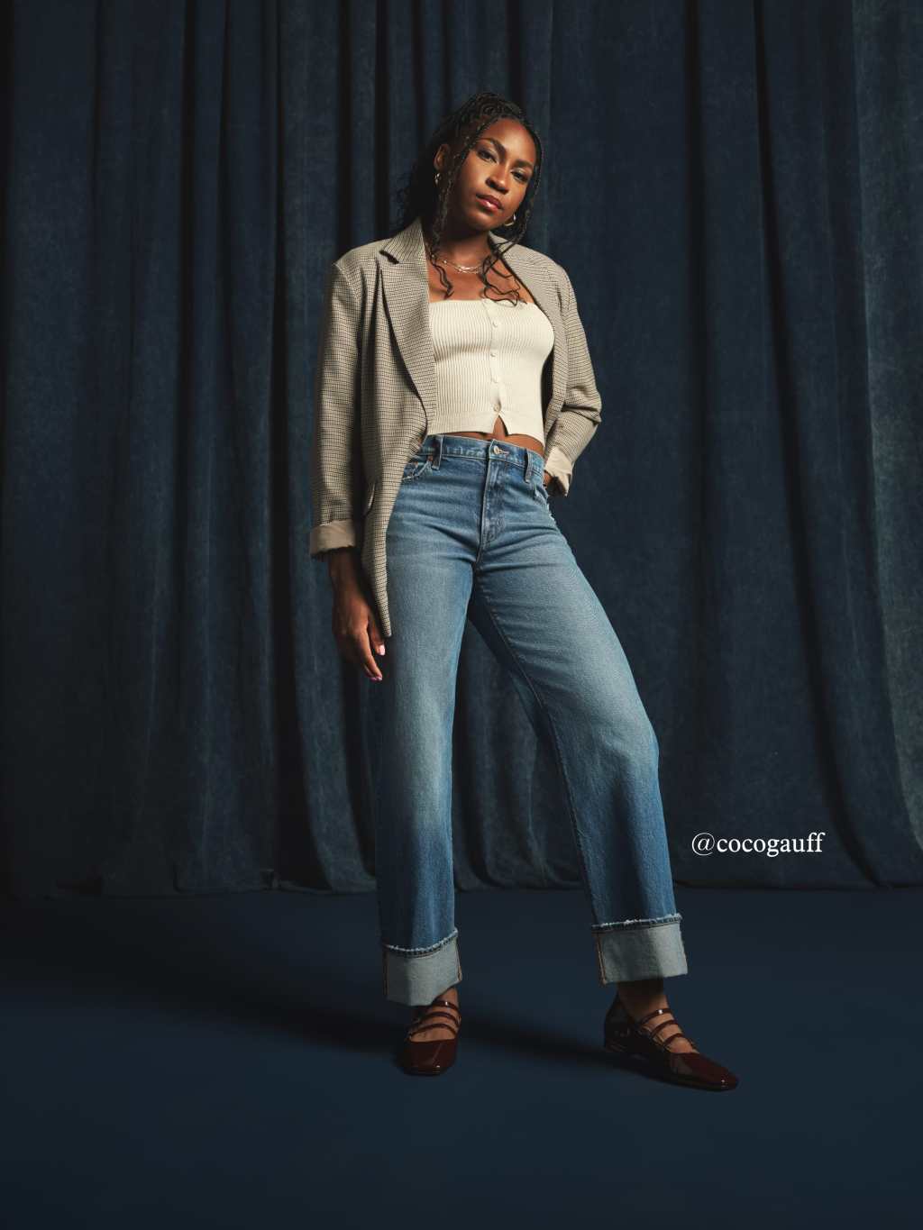 coco gauff wearing a white crop top, jacket, and medium wash stovepipe jeans from american eagle