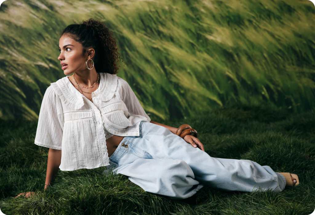 girl wearing a white blouse and blue jeans from american eagle