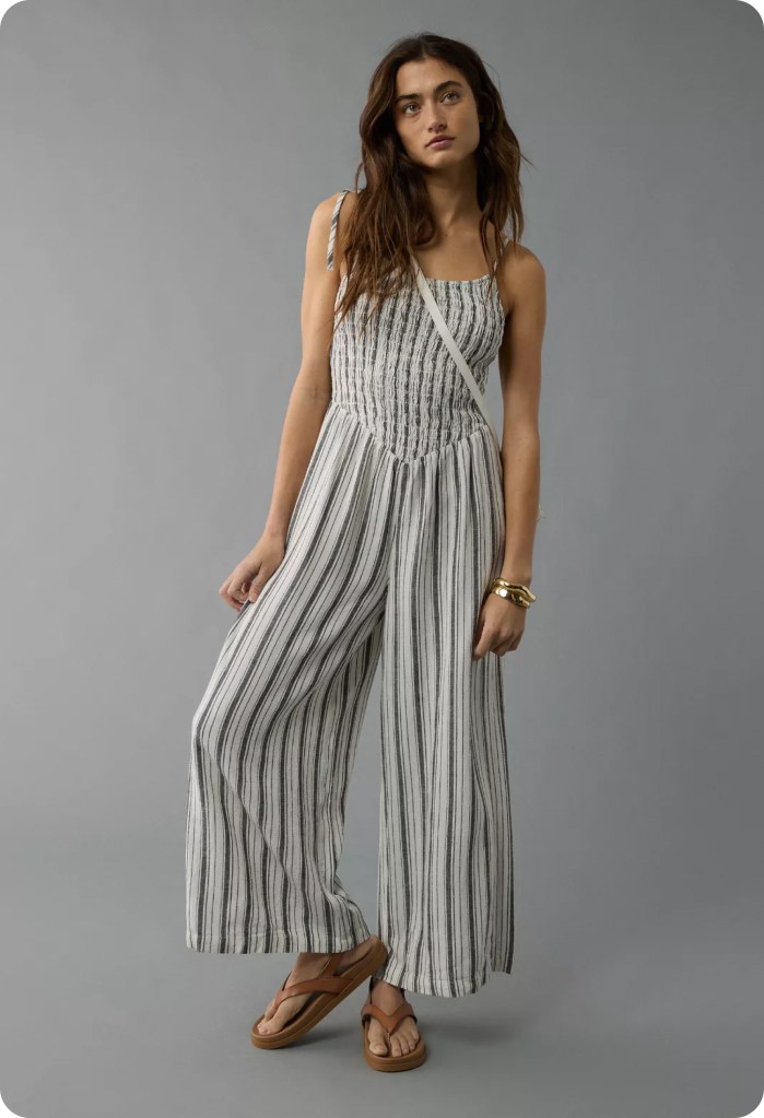 girl wearing a white and black striped jumpsuit from american eagle