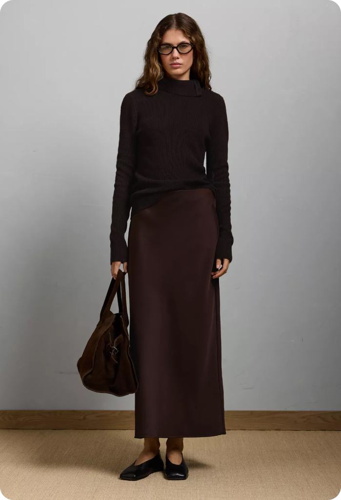 woman wearing a long maxi skirt and black turtleneck sweater office outfit from American Eagle