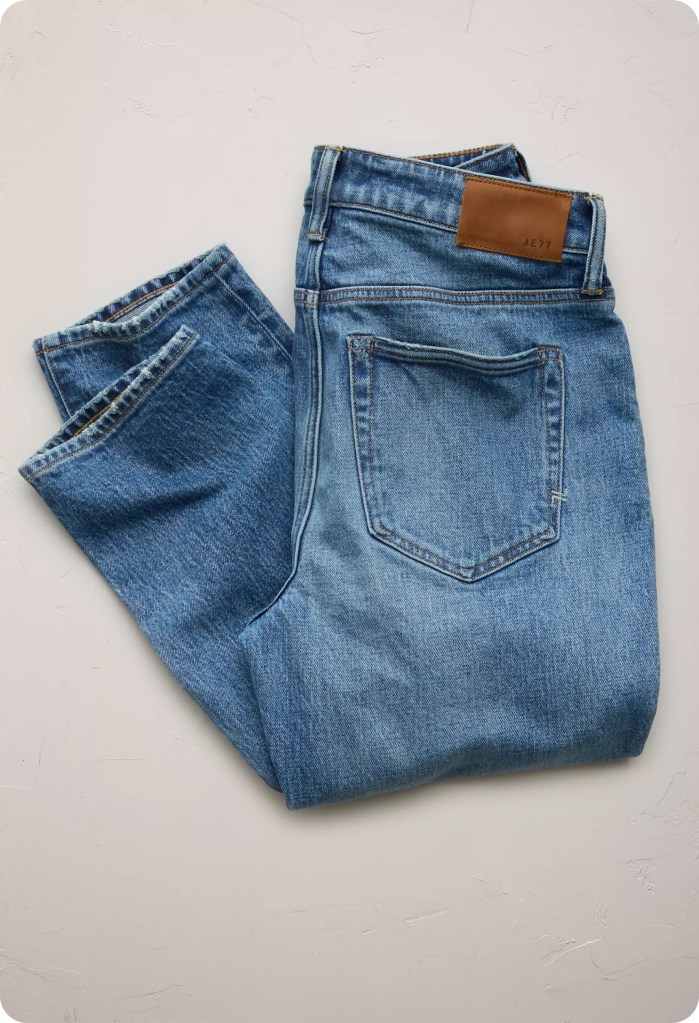 folded pair of medium wash cigarette jeans
