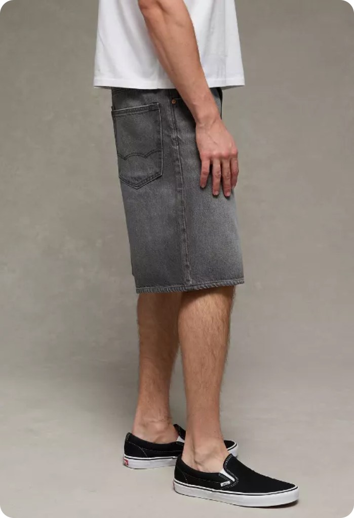 guy wearing black jorts and a white tshirt from american eagle