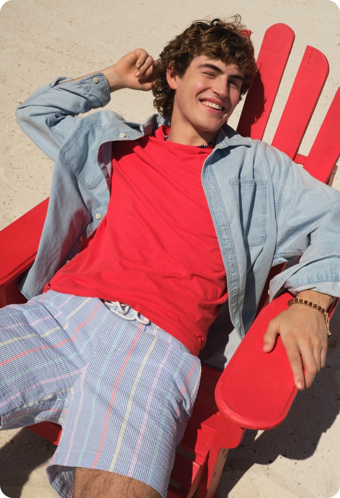 guy wearing a 4th of july outfit of a red tshirt and swim trunks from american eagle