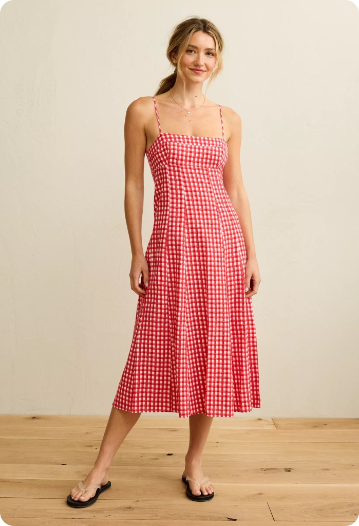 woman wearing a red and white plaid babydoll dress from american eagle