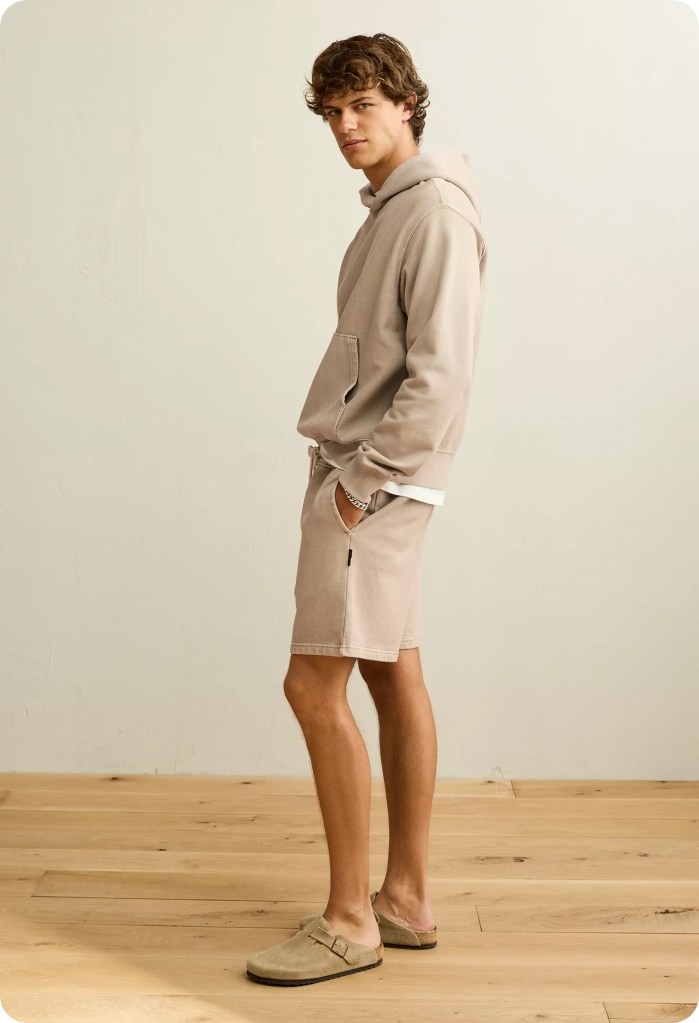 guy wearing a matching hoodie and sweat shorts from american eagle