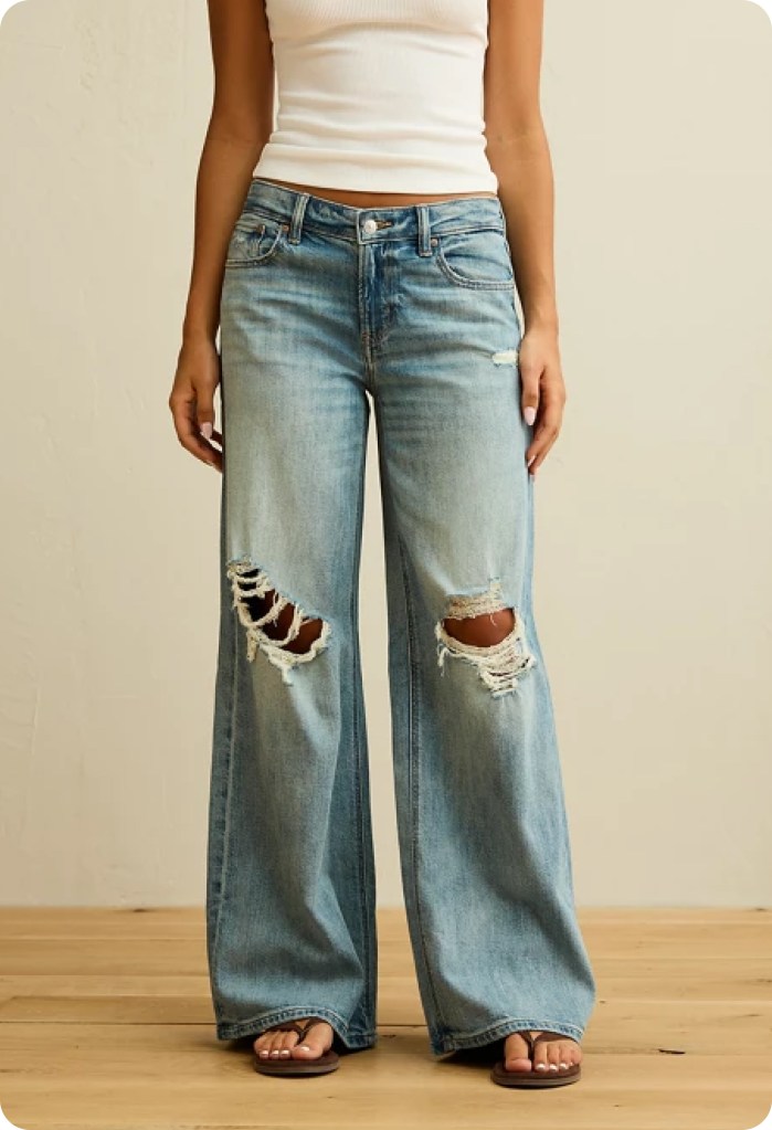 girl wearing ripped light wash baggy jeans from american eagle